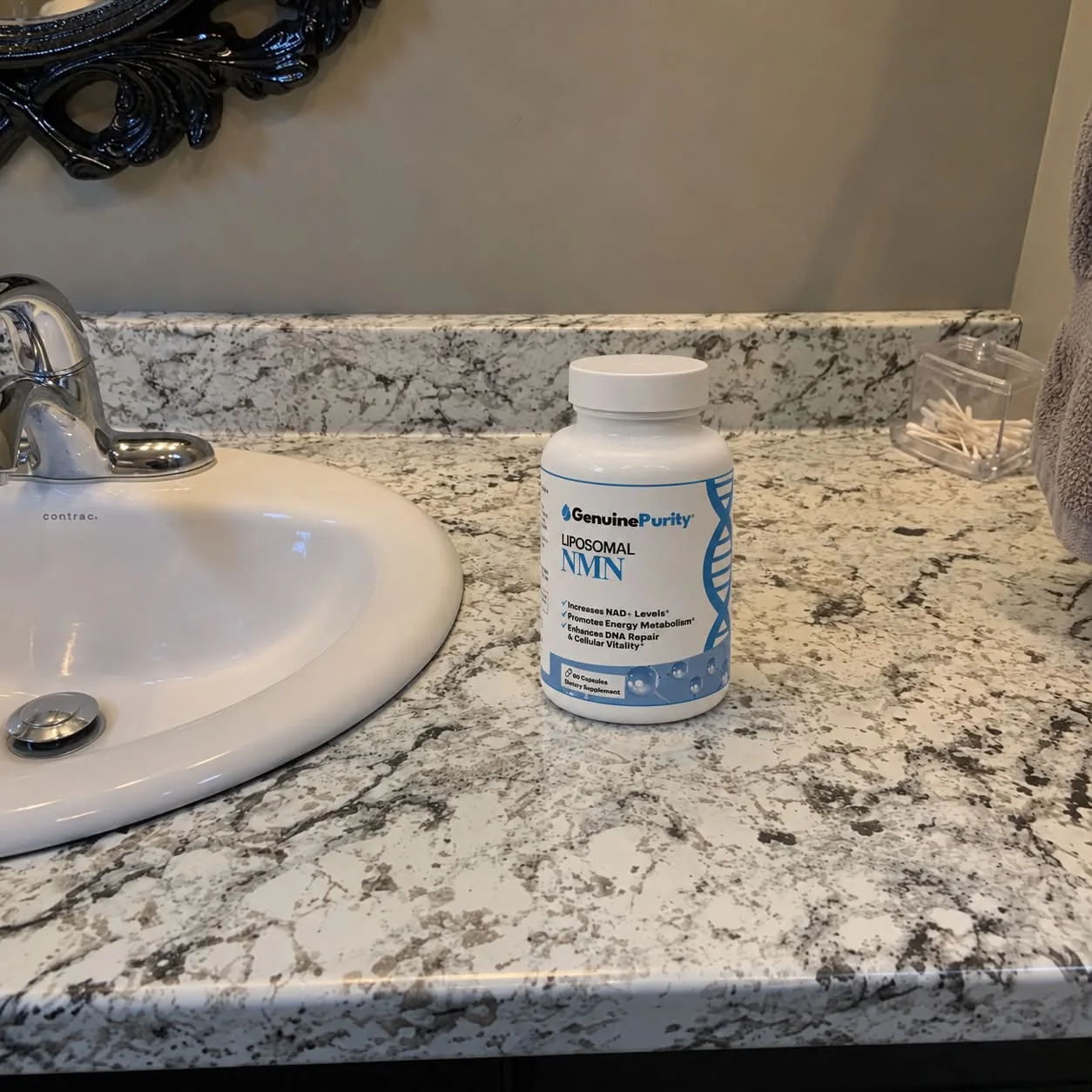 GenuinePurity Liposomal NMN bottle on a bathroom counter