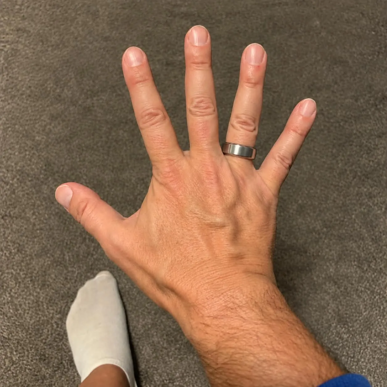 Tim Lekach wearing a brushed silver Oura Ring 5